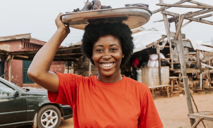 medium-shot-woman-carrying-food-head